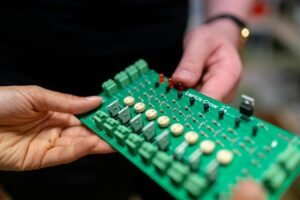 Engineers Holding Circuit Board Image of circuit board